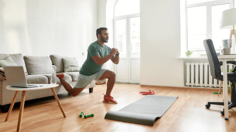 young man doing exercise in his apartment